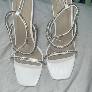 White heels with diamanté detailing.